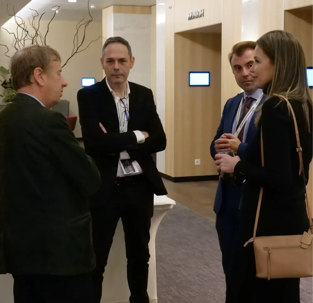 Researchers discussing scientific findings during a poster presentation session at an international healthcare and medical research conference.